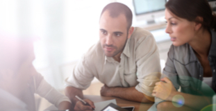 Couple applying for a debt consolidation loan at a bank